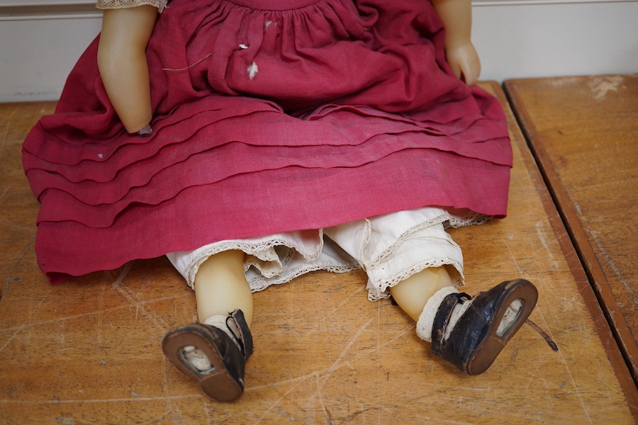 A 19th century poured wax shoulder doll, paperweight eyes and jointed limbs, 60cm. Condition - some damage